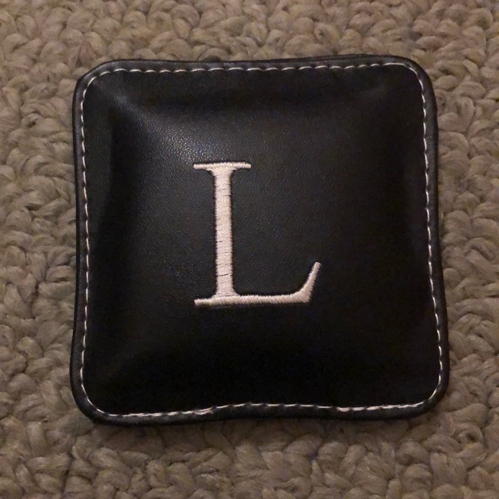 Leathery paperweight with L on it
